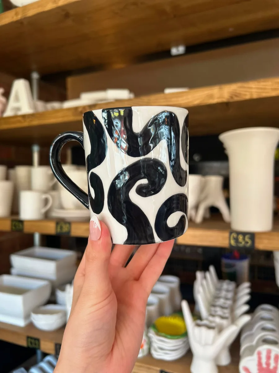 Hand-painted black swirl mug at art-ful pottery café Worthing
