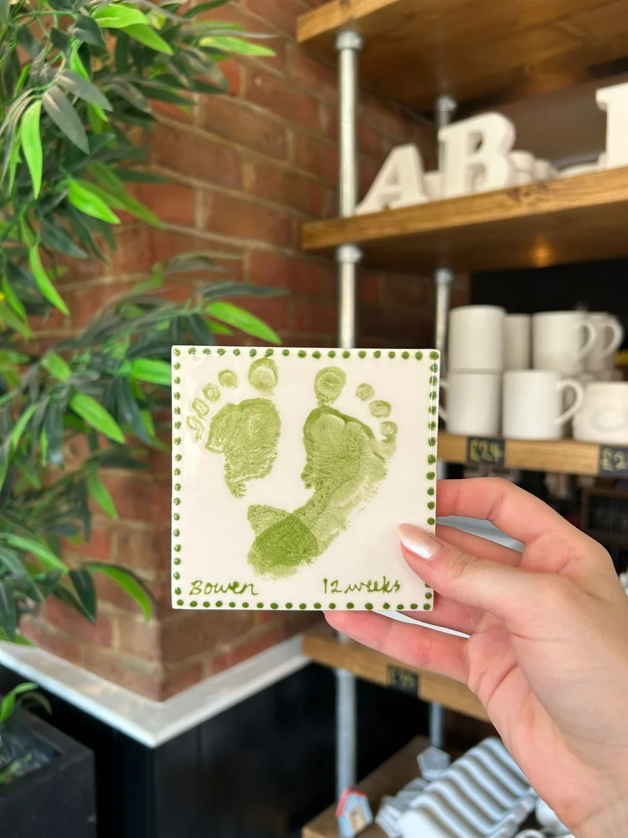 Hand-painted baby footprint tile at art-ful pottery café Worthing