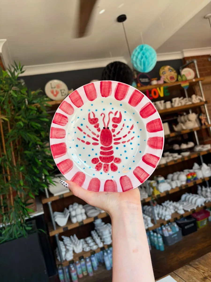 Hand-painted lobster side plate at art-ful pottery café Worthing