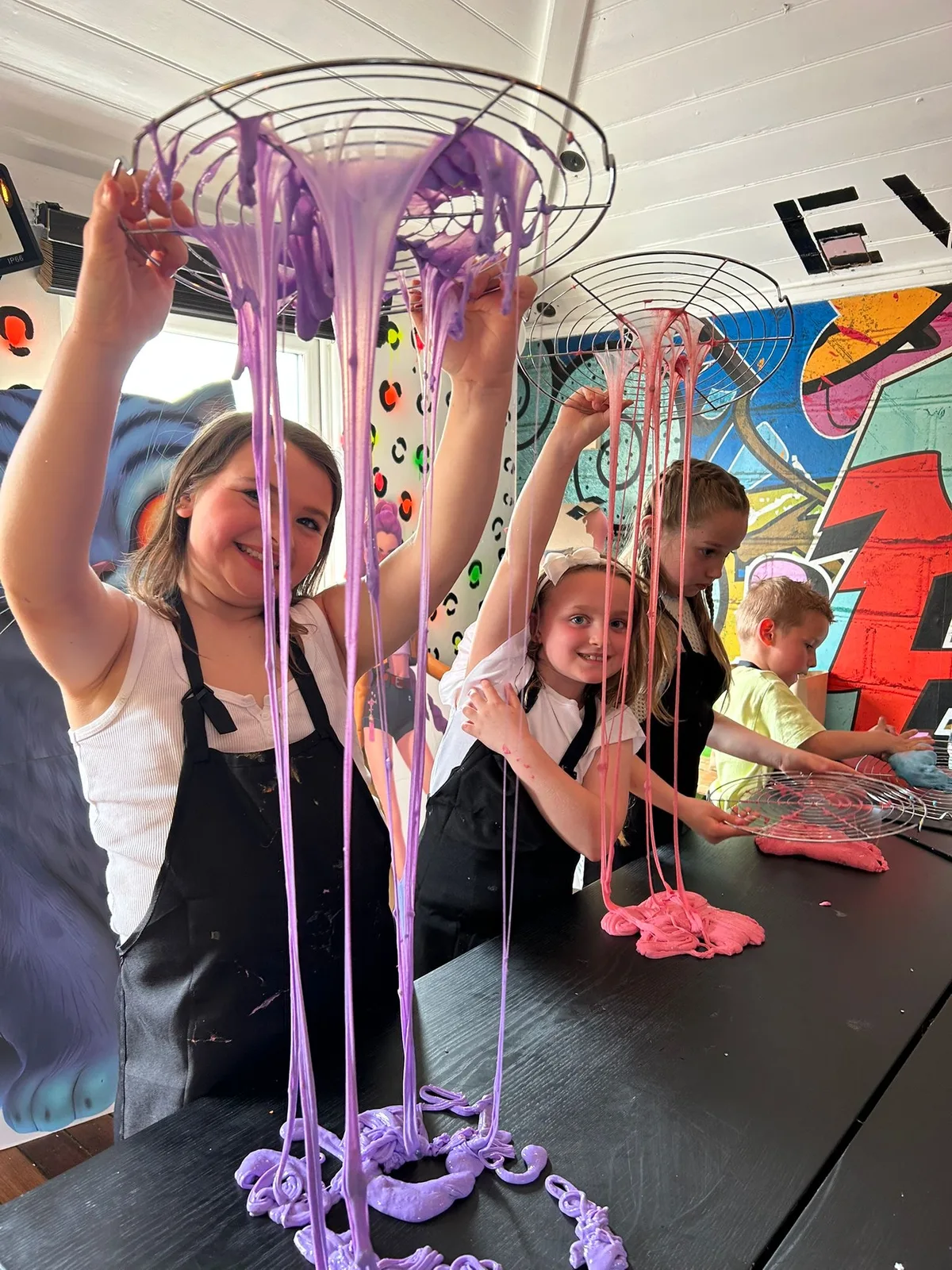 Children stretching purple slime at art-ful Worthing