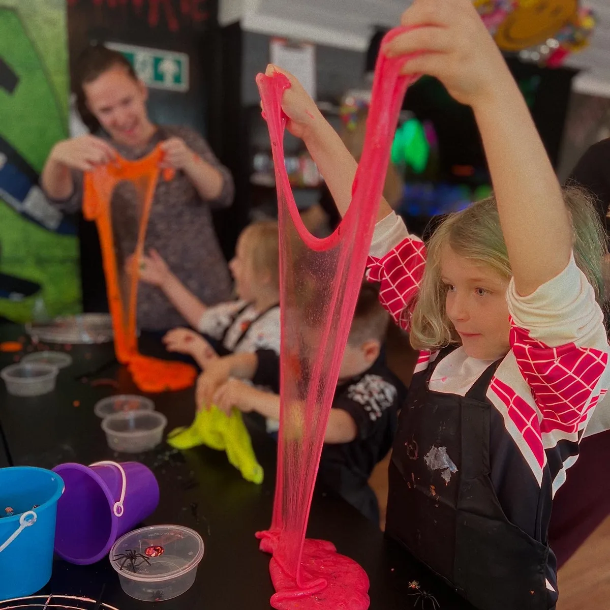 Child holding up pink slime at art-ful Worthing